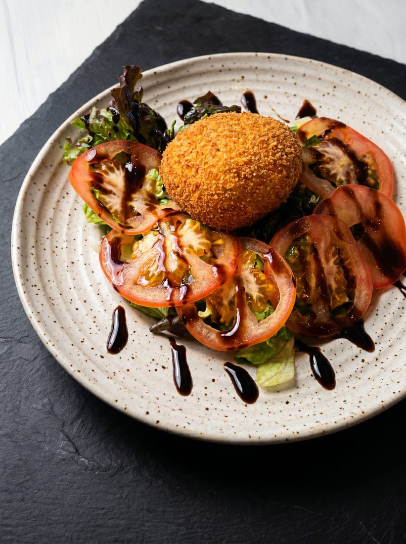 After — Scotch egg starter — phone photo relit to studio quality with PlateRefresh