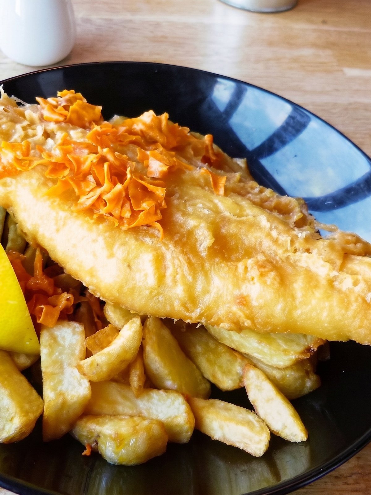 After: studio-lit menu photo of the same fried fish and chips with crisp golden batter and clean presentation