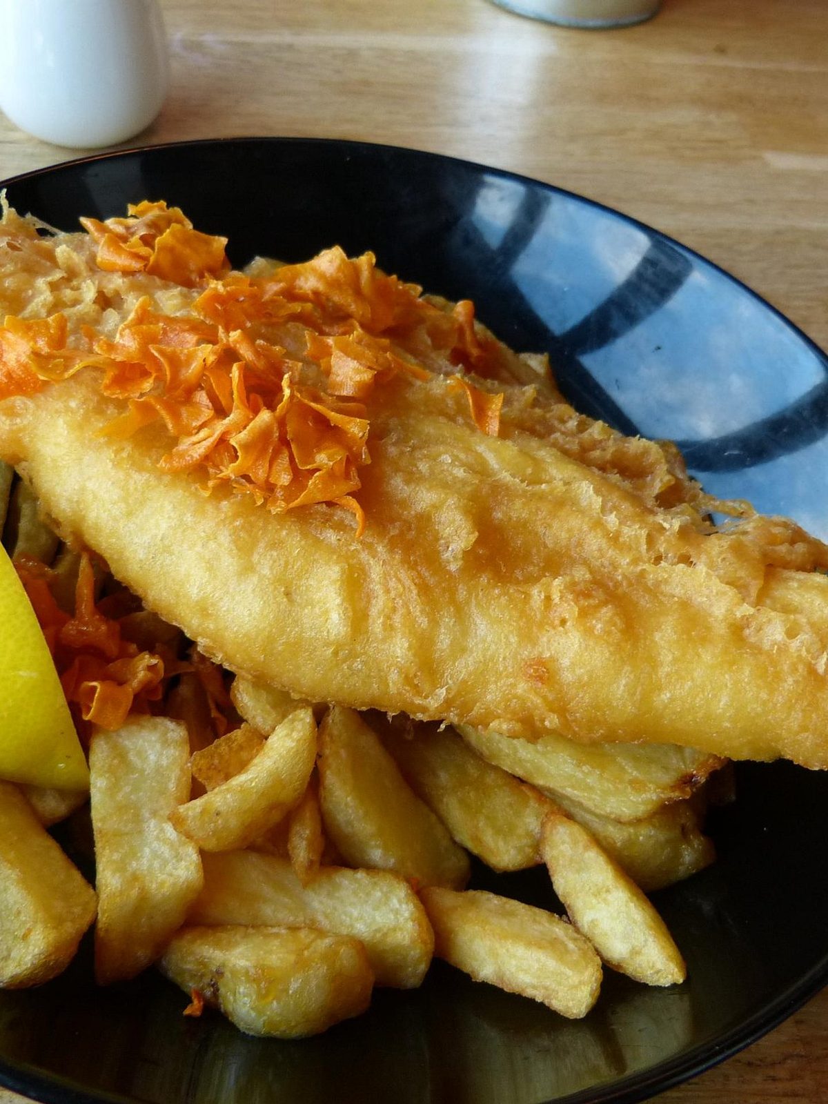 Before: dim phone photo of fried fish with chips on a counter under flat overhead light