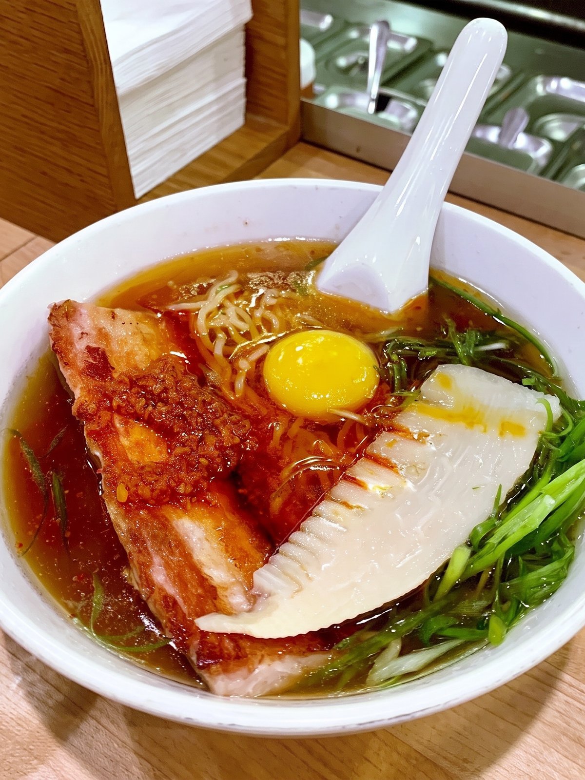After: cleanly lit studio menu photo of the same bowl of ramen with glossy broth and vivid toppings